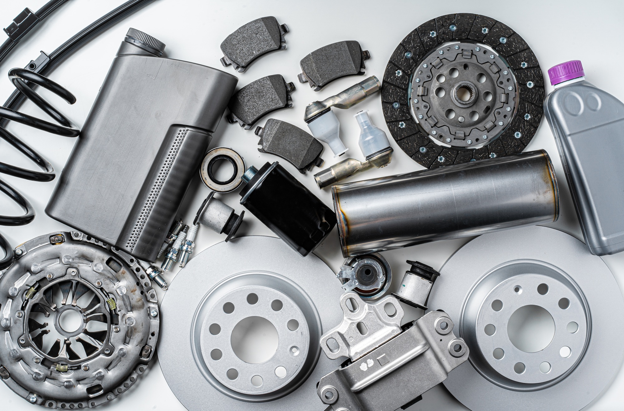 New metal auto parts on grey background